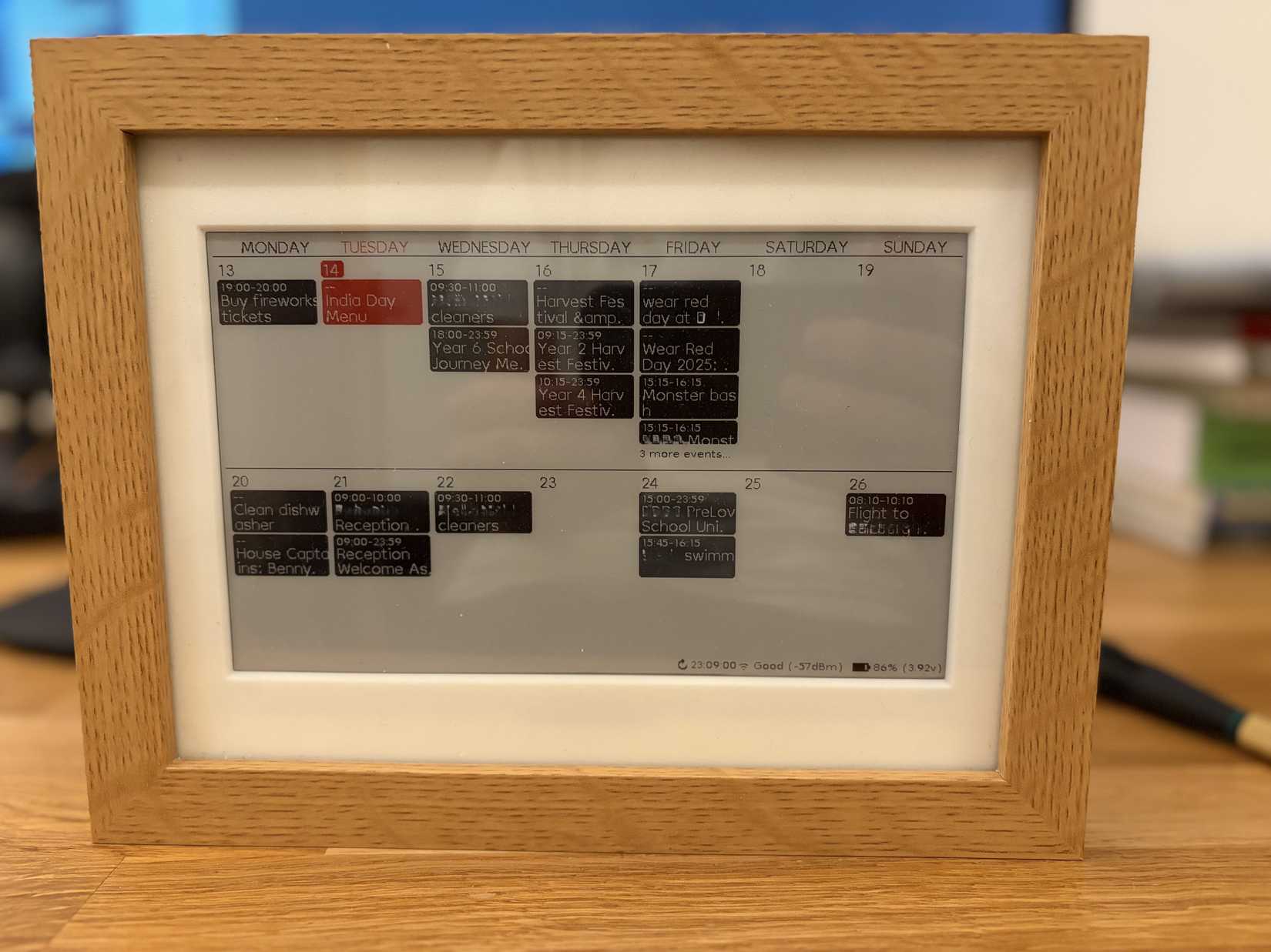 ESP32 e-ink calendar in a wooden frame.