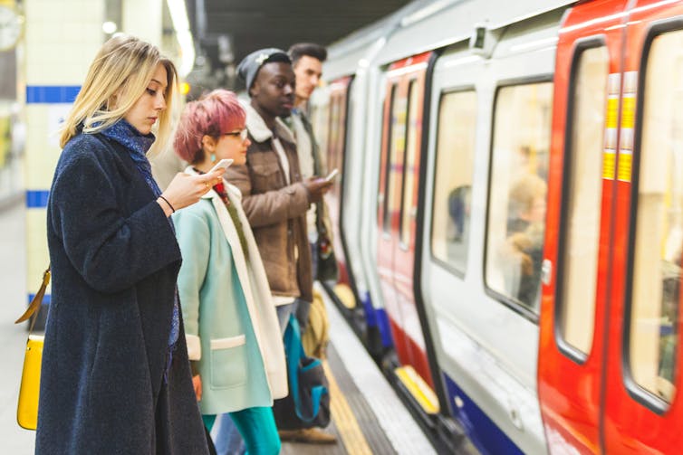 Commuters waiting for a London tube train