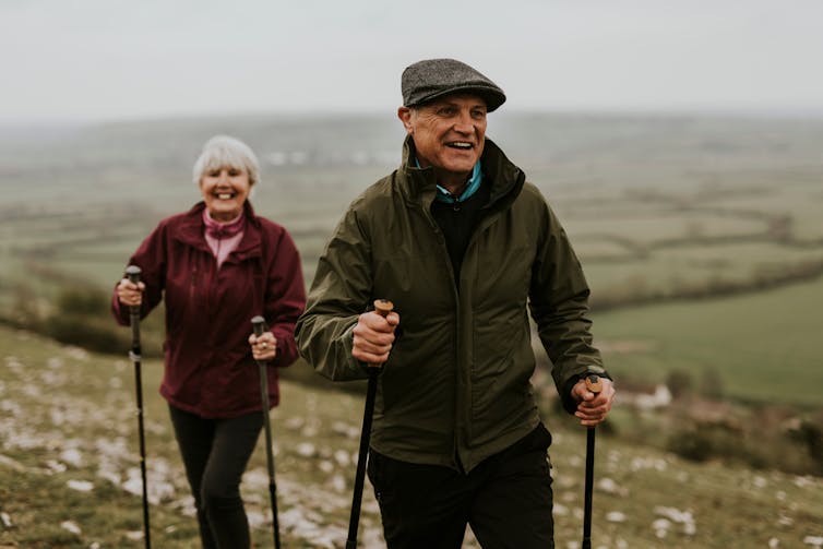 Two older people out walking in the countryside