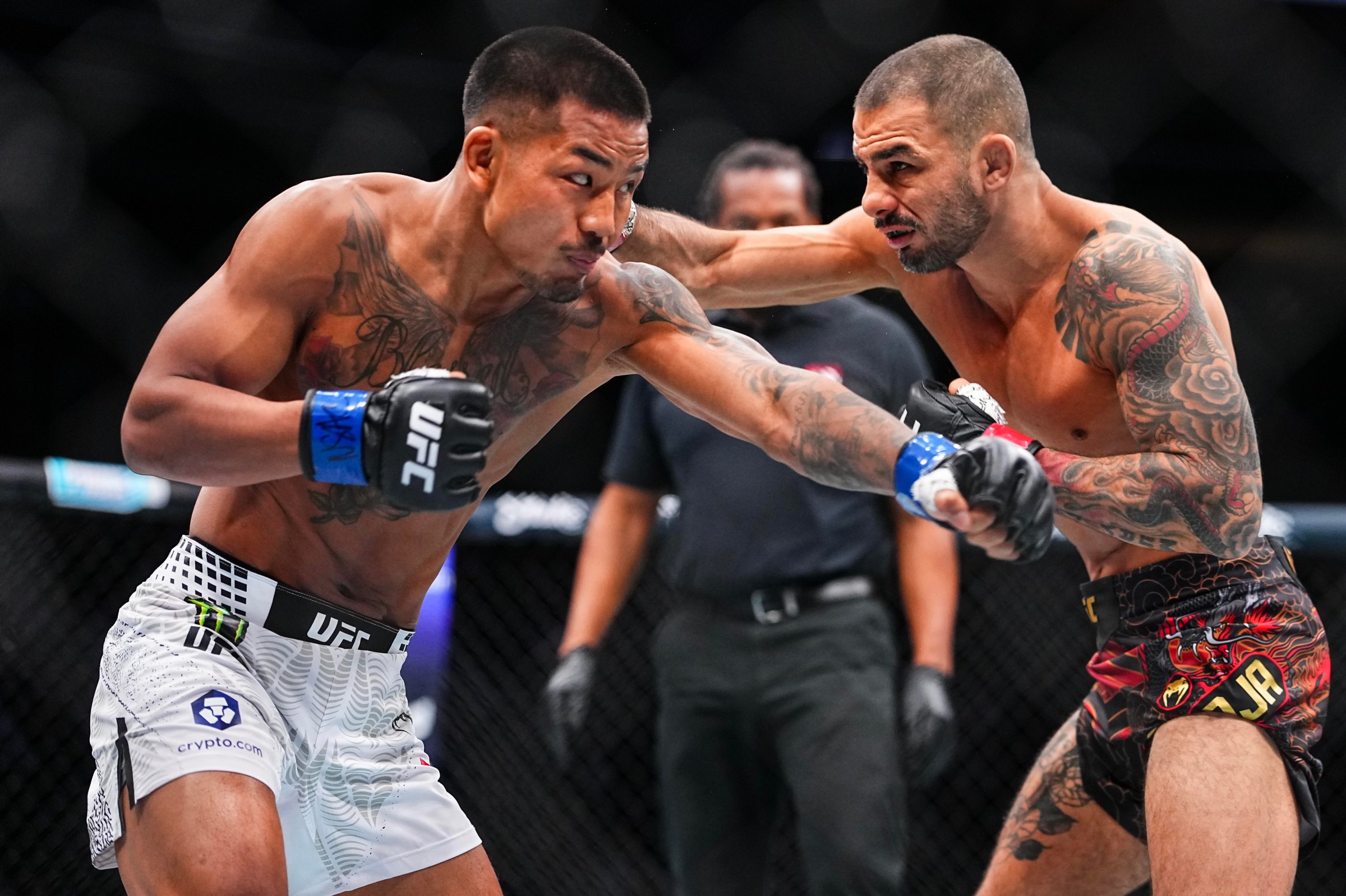 LAS VEGAS, NEVADA - DECEMBER 06: (L-R) Joshua Van of Myanmar trades punches with Alexandre Pantoja of Brazil in the UFC flyweight championship fight during the UFC 323 event at T-Mobile Arena on December 06, 2025 in Las Vegas, Nevada. (Photo by Chris Unger/Zuffa LLC)