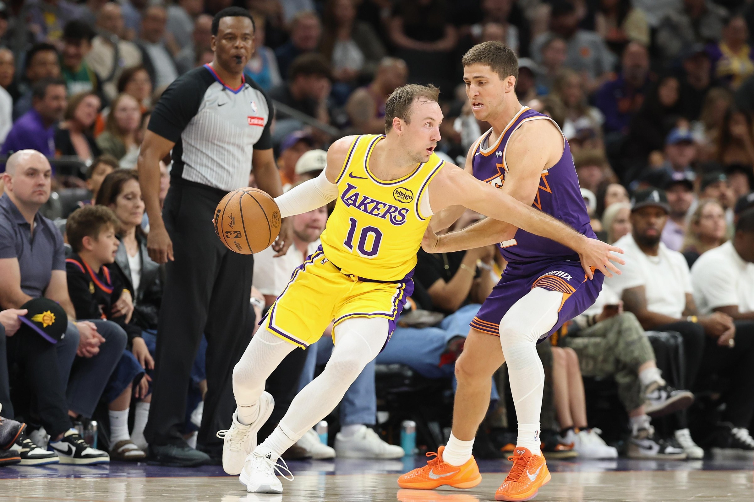 PHOENIX, ARIZONA - FEBRUARY 26: Luke Kennard #10 of the Los Angeles Lakers handles the ball against Collin Gillespie #12 of the Phoenix Suns during the second half of the NBA game at Mortgage Matchup Center on February 26, 2026 in Phoenix, Arizona. The Suns defeated the Lakers 113-110. NOTE TO USER: User expressly acknowledges and agrees that, by downloading and or using this photograph, user is consenting to the terms and conditions of the Getty Images License Agreement. (Photo by Christian Petersen/Getty Images)