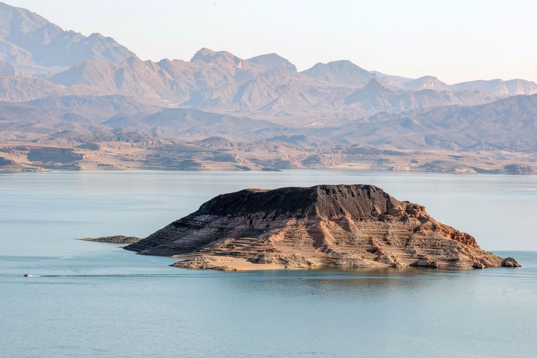 A boat cruises near Sentinel Island in Lake Mead on July 25.en the seven states on water rights and usage.