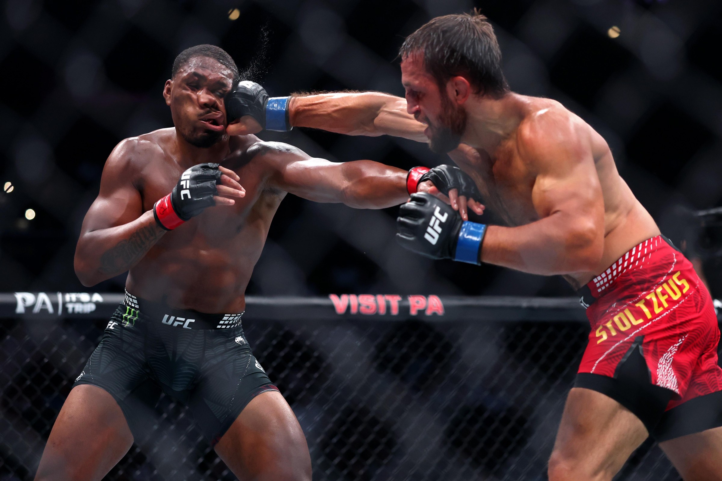 PHILADELPHIA, PENNSYLVANIA - AUGUST 15: Mansur Abdul-Malik of the United States is punched by Dustin Stoltzfus of the United States in a middleweight bout during UFC 330 at Xfinity Mobile Arena on August 15, 2026 in Philadelphia, Pennsylvania. (Photo by Caleb Bowlin/Getty Images)