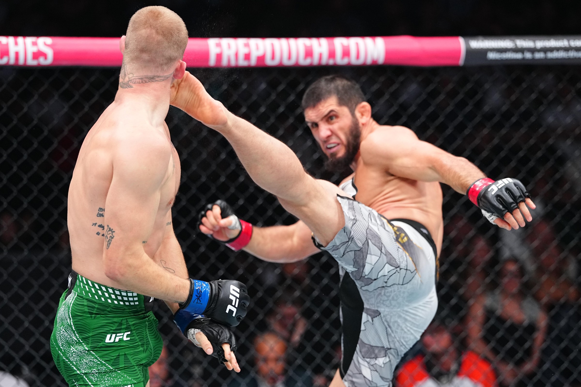 PHILADELPHIA, PENNSYLVANIA - AUGUST 15: (R-L) Islam Makhachev of Russia kicks Ian Machado Garry of Ireland in the UFC welterweight championship fight during the UFC 330 event at Xfinity Mobile Arena on August 15, 2026 in Philadelphia, Pennsylvania. (Photo by Chris Unger/Zuffa LLC)