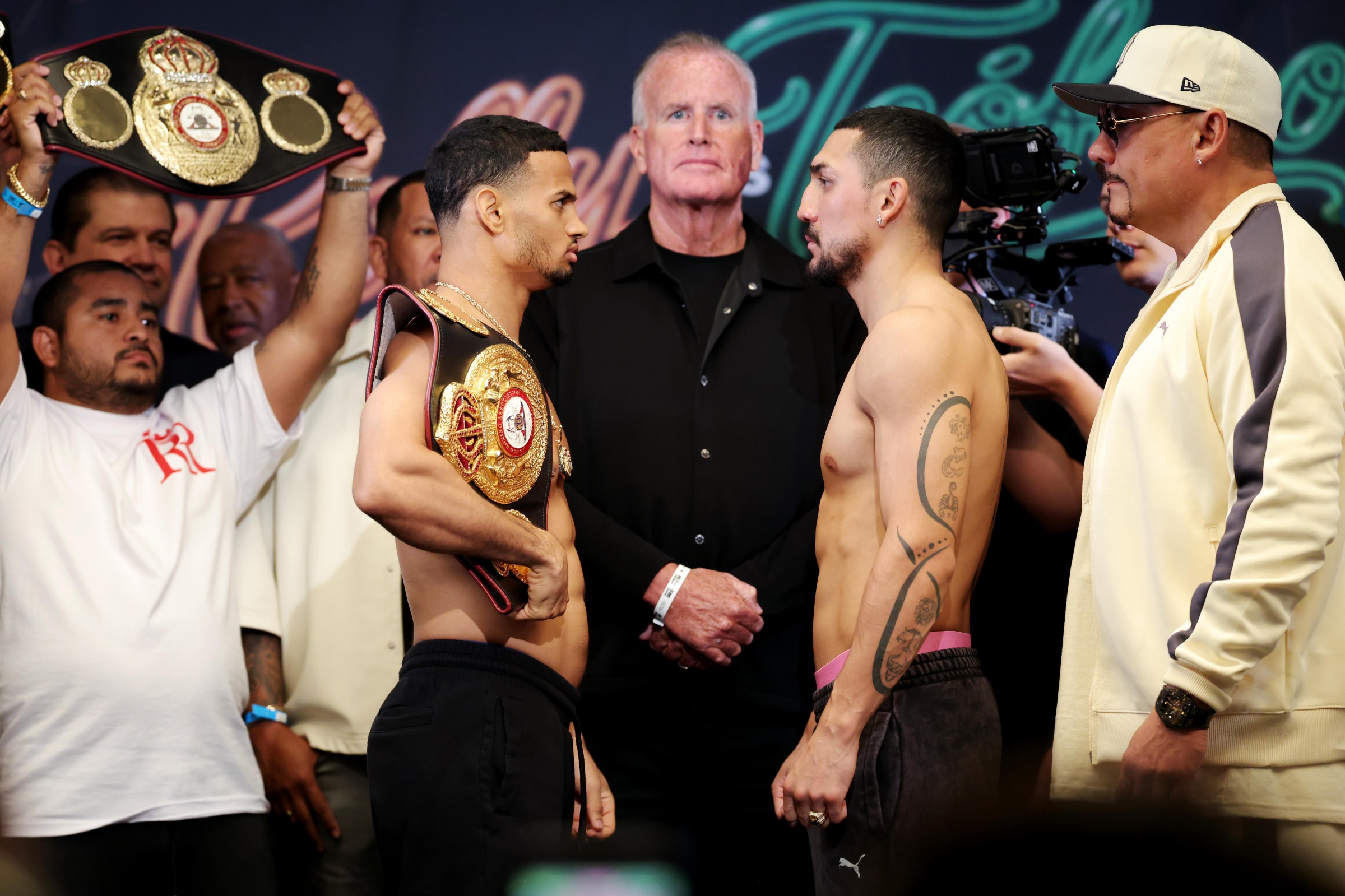 LAS VEGAS, NEVADA - AUGUST 21: Rolly Romero (L) and Teofimo Lopez (R) face off prior to their WBA Welterweight fight at the Presidio Ballroom at Park MGM on August 21, 2026 in Las Vegas, Nevada. (Photo by Cris Esqueda/Getty Images)