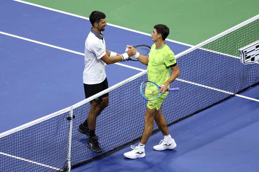 Mariano Navone embraces Djokovic after the match.