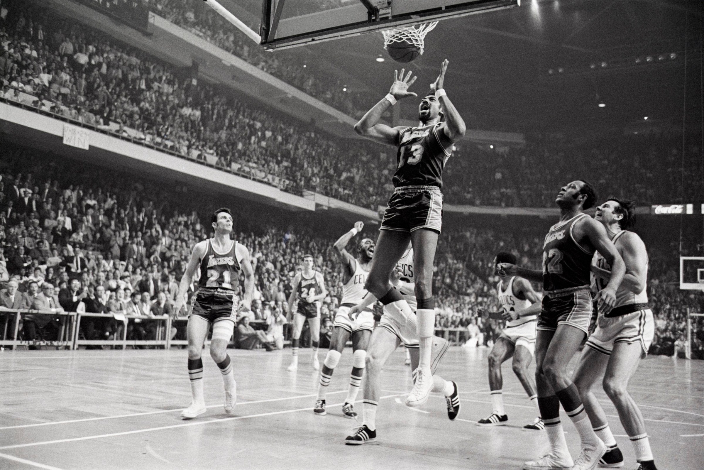 Wilt Chamberlain (13) grimaces as Sam Jones’ winning basket drops through the net with one second left in Game 4 at the Boston Garden.