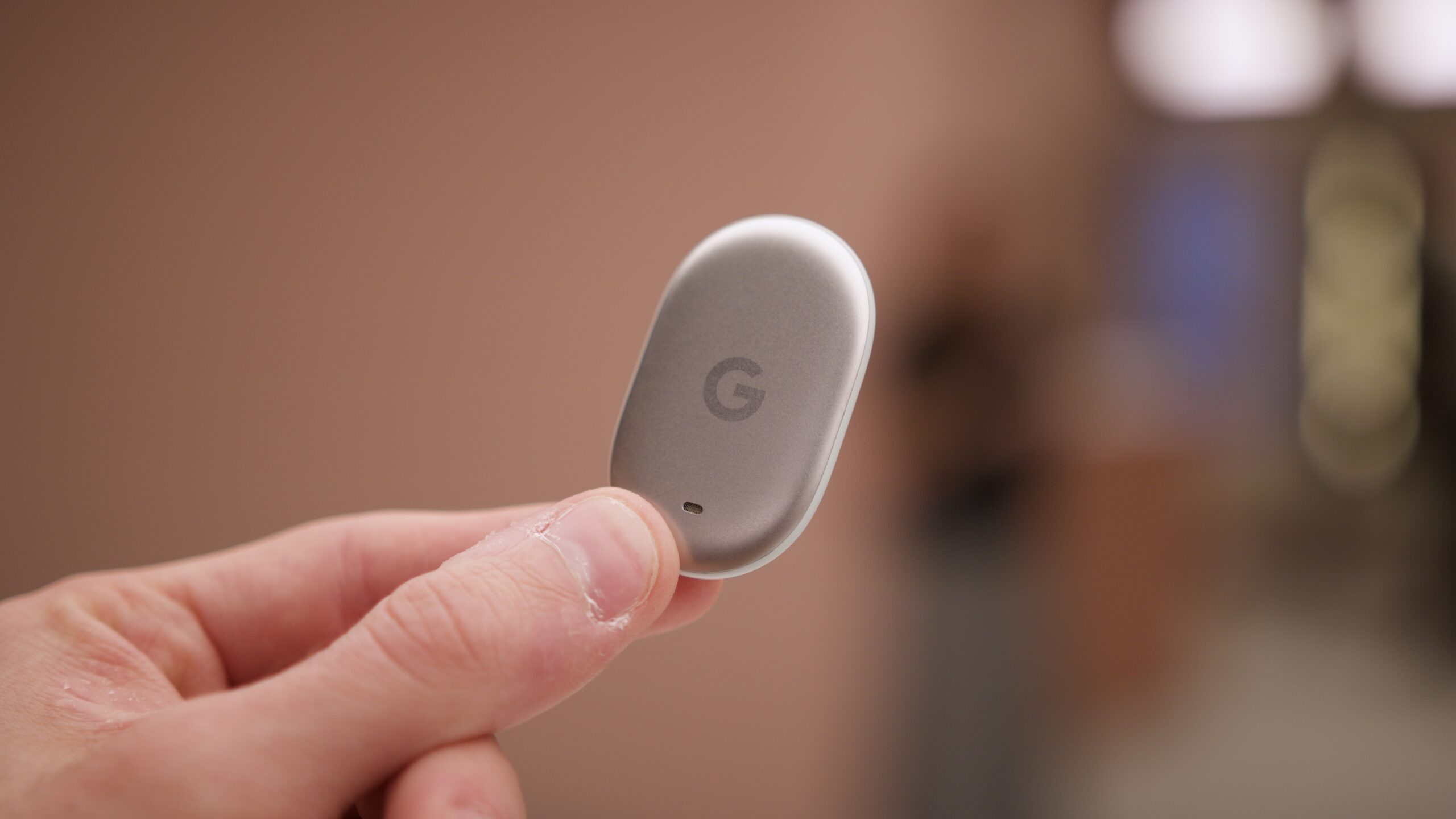 Holding the Google Pixel Tag.