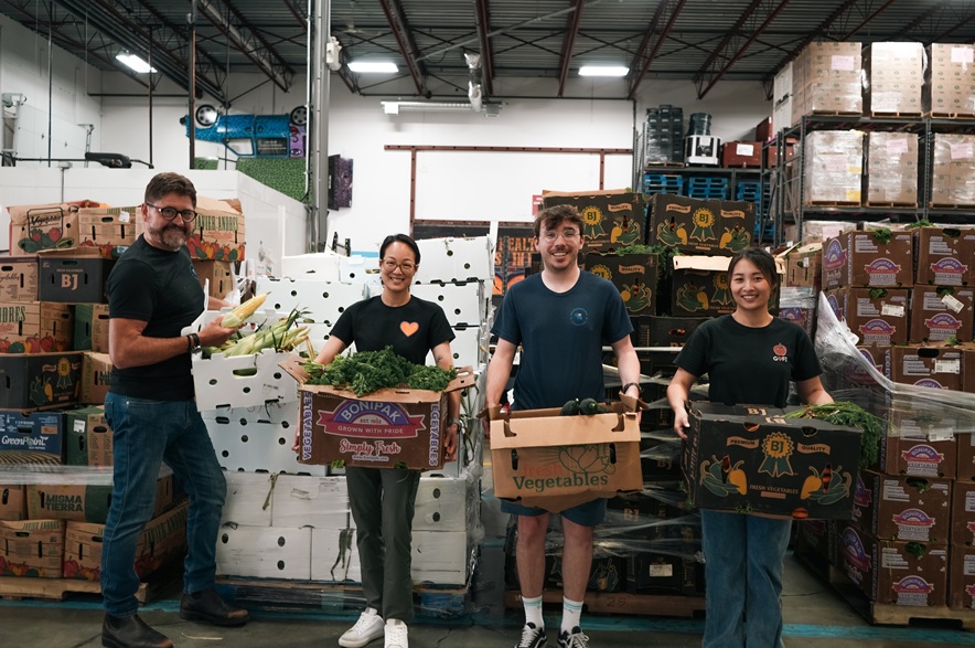 Workers at the Greater Vancouver Food Bank pack produce destined for Regina.