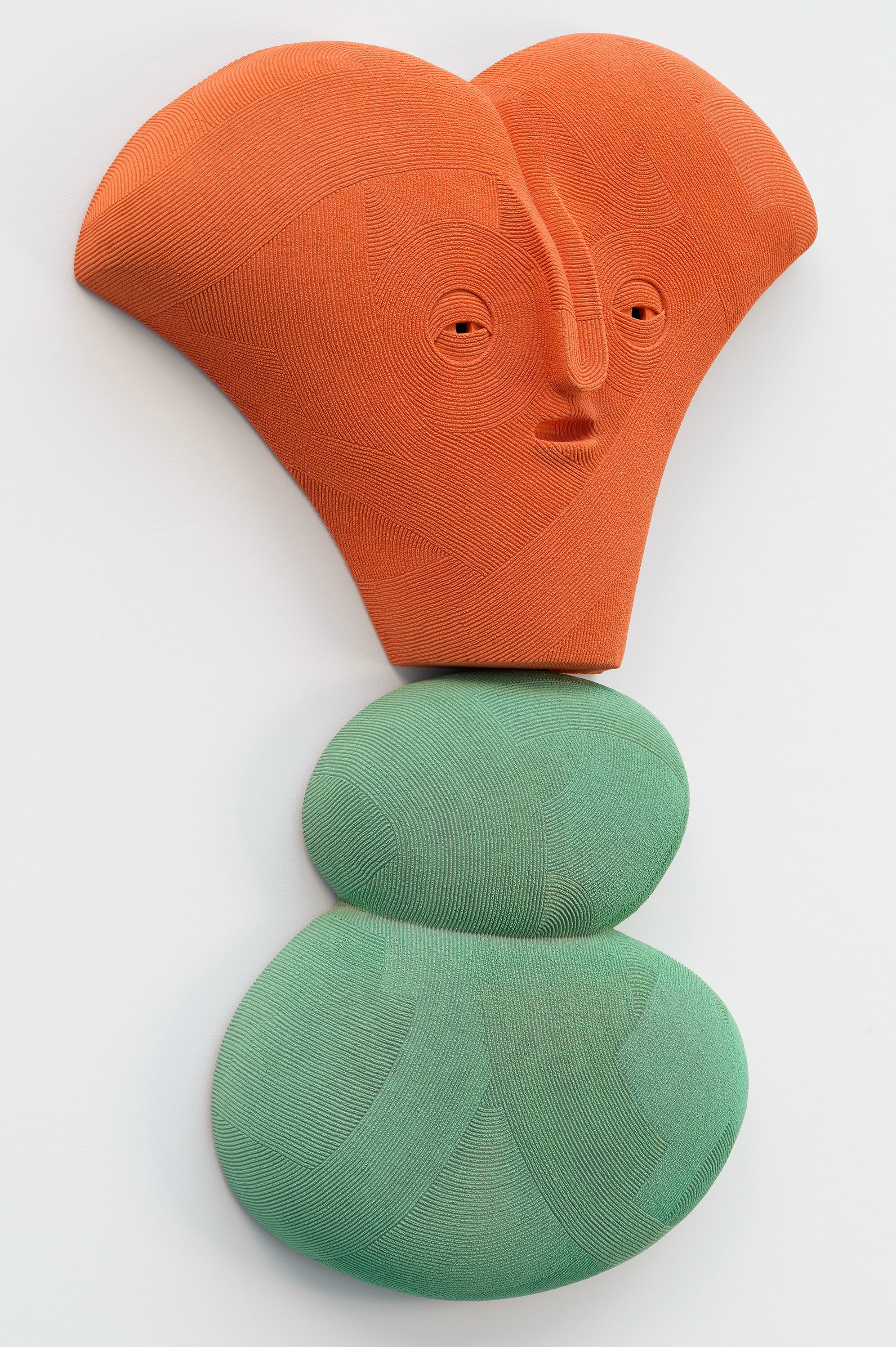 an abstract ceramic sculpture by en iwamura with a tiny face