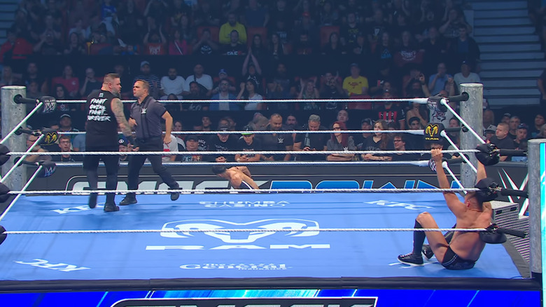 All three men inside and around the ring