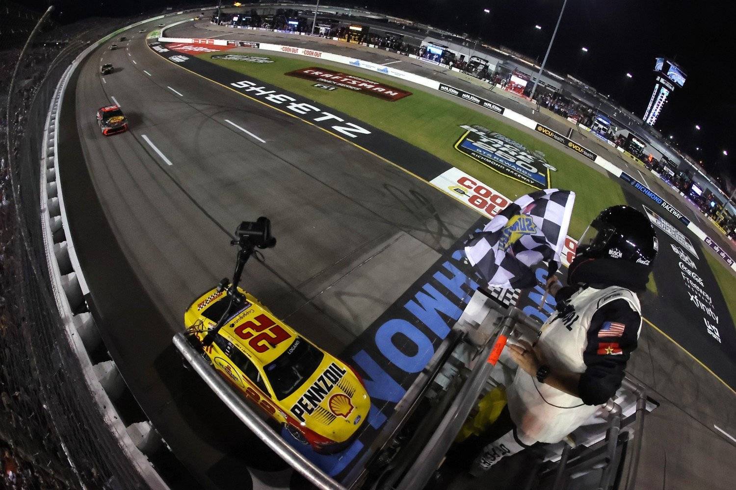 Joey Logano, driver of the #22 Shell Pennzoil Ford, takes the checkered flag to win the NASCAR Cup Series Cook Out 400 at Richmond Raceway on August 15, 2026 in Richmond, Virginia. (Photo by Jonathan Bachman/Getty Images for NASCAR)