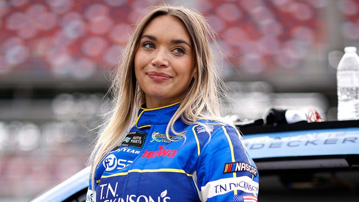 Natalie Decker standing on the grid at Talladega Superspeedway during qualifying