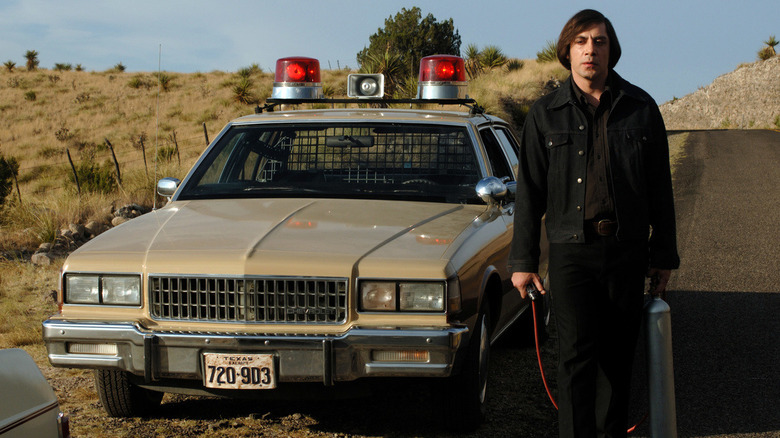 Anton Chigurh stands by a cop car in 