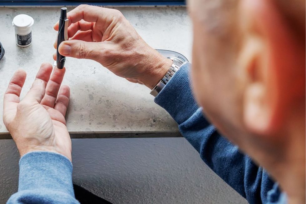 PERSON CHECKING BLOOD SUGAR