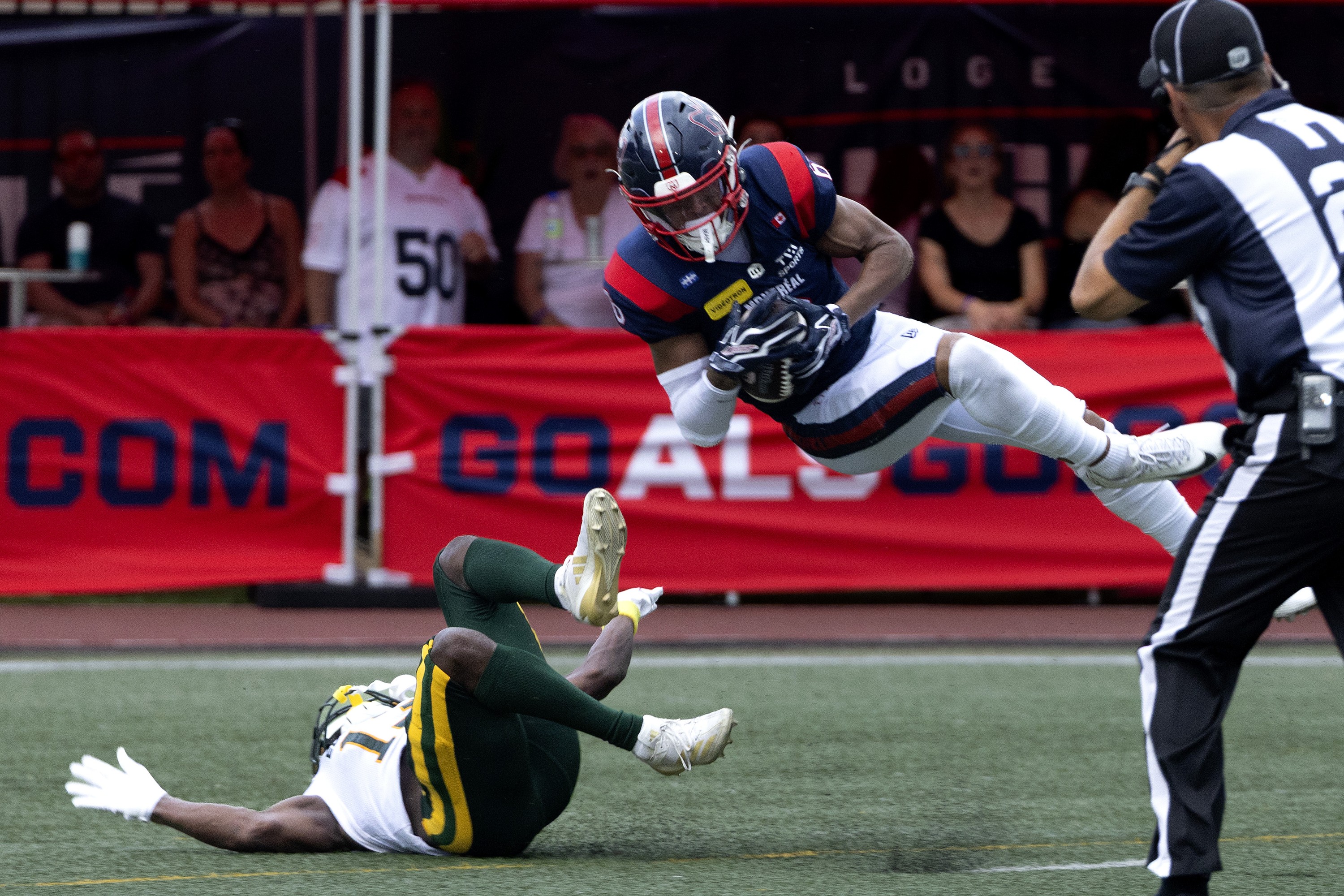 Alouettes receiver Tyson Philpot scores a touchdown over Edmonton Elks defensive-back Kordell Jackson in Montreal on Aug. 8.