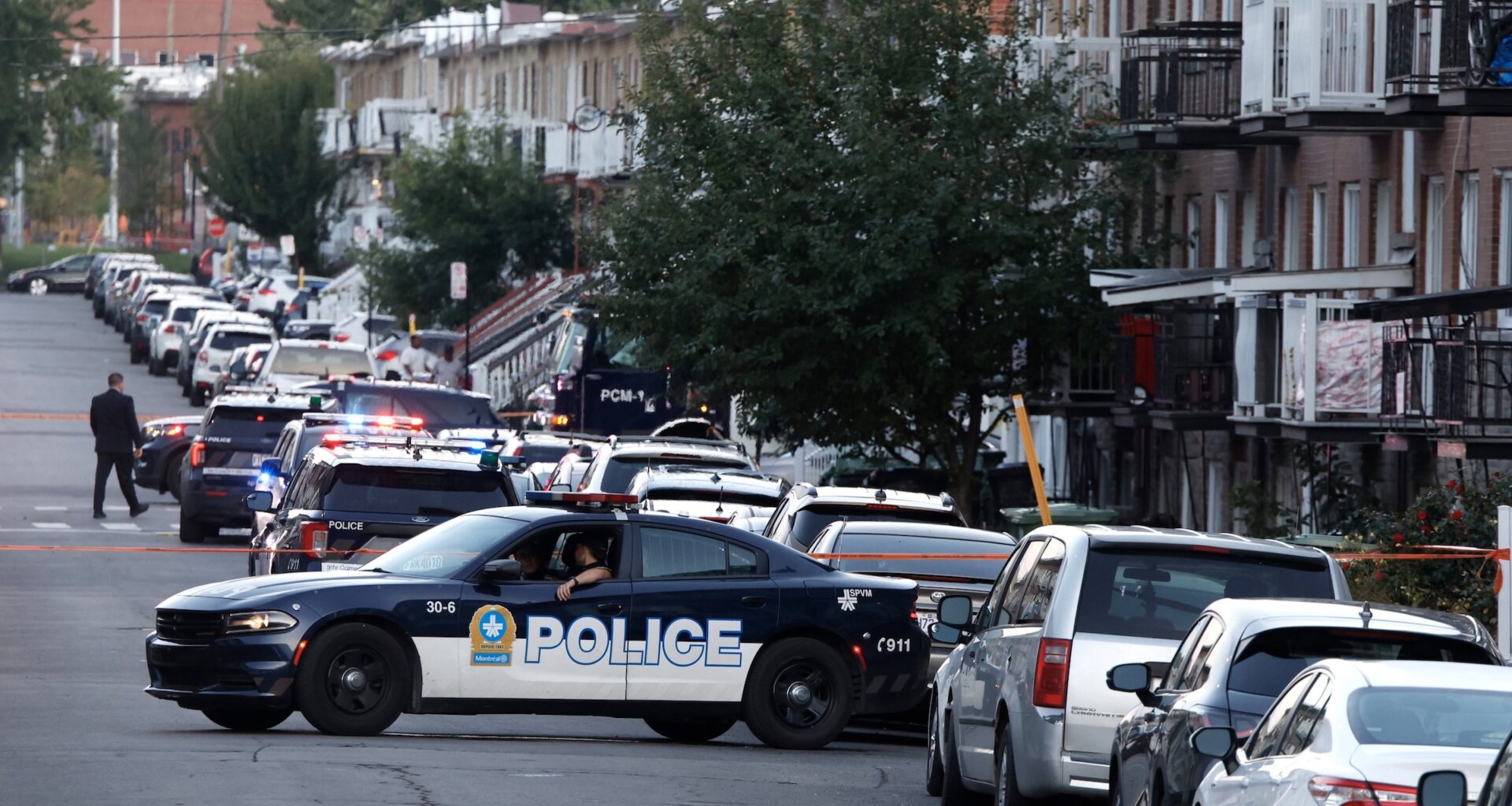 Police vehicles are seen on a residential street.
