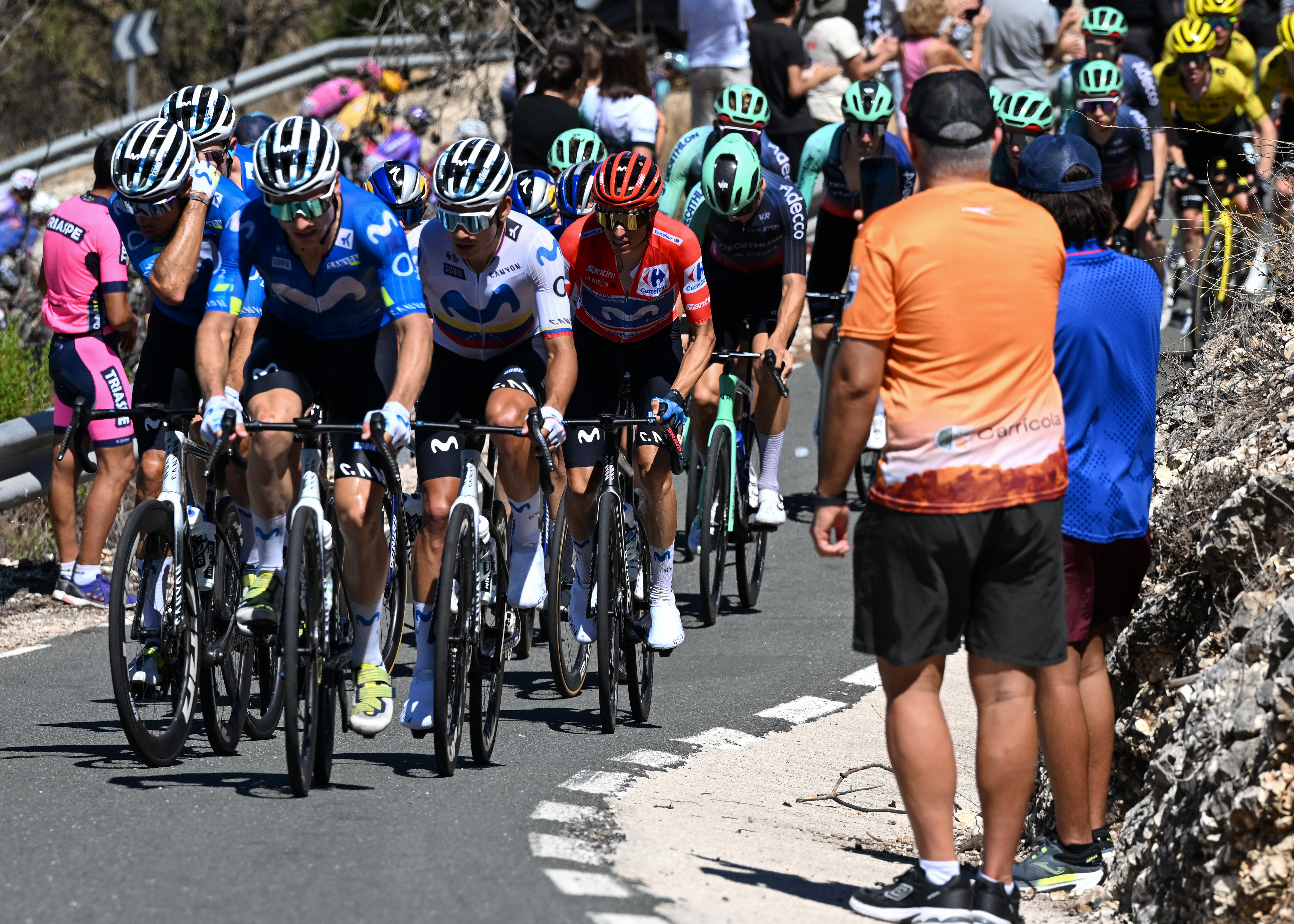 ALTO DE AITANA, SPAIN - AUGUST 30: Enric Mas of Spain and Movistar Team - Red Leader Jersey (R) with teammates compete passing the Puerto de Tollos (830m) during the La Vuelta - 81st Tour of Spain 2026, Stage 9 a 187.4km stage from Villajoyosa to Alto de Aitana 1544m / #UCIWT / on August 30, 2026 in Alto de Aitana, Spain. (Photo by Tim de Waele/Getty Images)