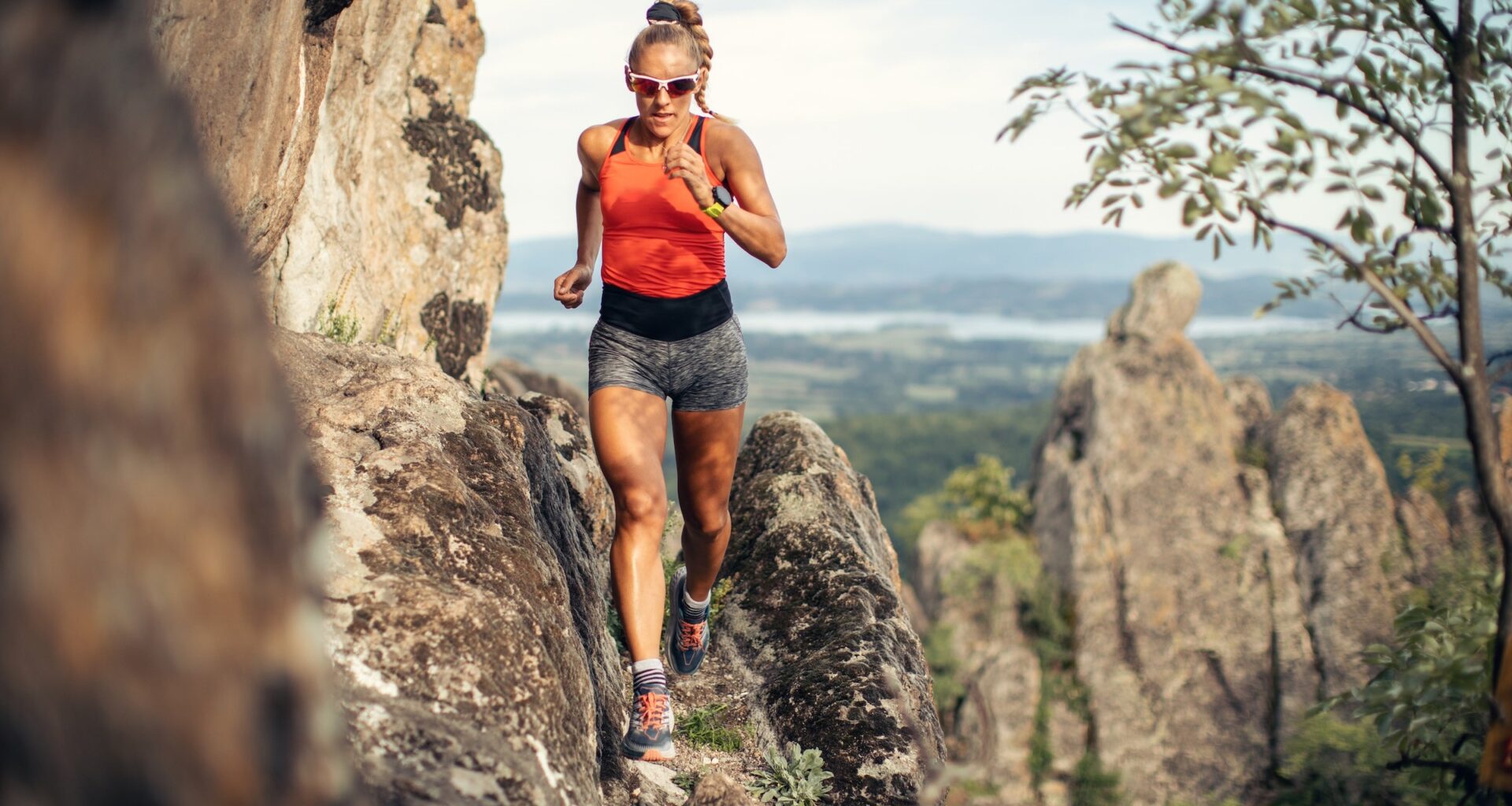 woman running on mountain cliff