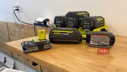 Various Ryobi 18V and 40V batteries on a table
