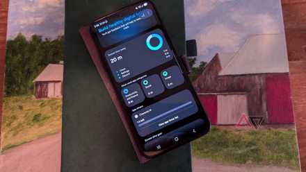 A Samsung Galaxy S25+ device with the google digital wellbeing section showing app timer and limited screen time while sitting on a notebook and painting