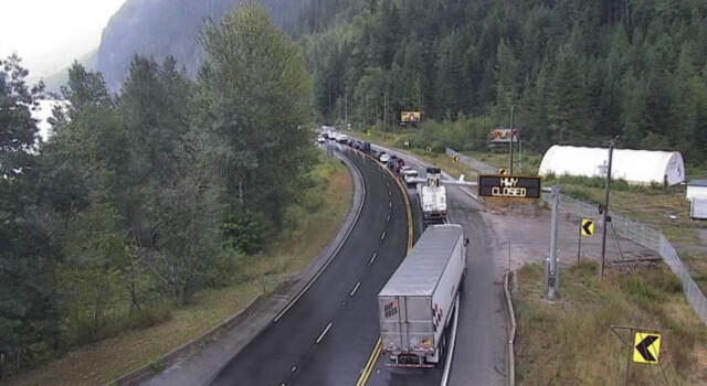 Cars backed up along Highway 1 about 20 km west of Revelstoke near Three Valley Gap, looking east.