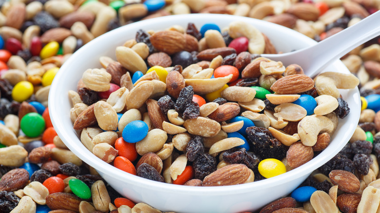 trail mix in a white bowl with white spoon