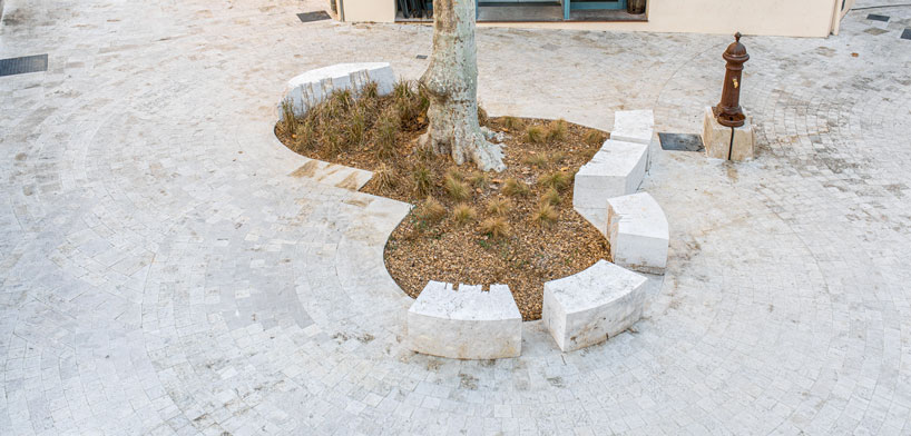 carved travertine transforms paving, furniture, and planting across spanish historic old town - 2