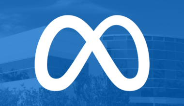 Meta logo on blue filter with office building in background.