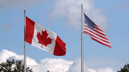 A US and a Canadian flag flutter at the Canada-United States border crossing at the Thousand Islands Bridge, which remains closed to non-essential traffic to combat the spread of the coronavirus disease (Covid-19) in Lansdowne, Ontario, Canada September 28, 2020. Photo :Reuters