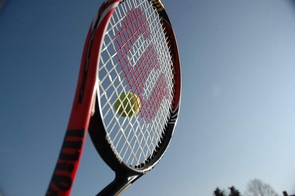 Racket hitting a tennis ball