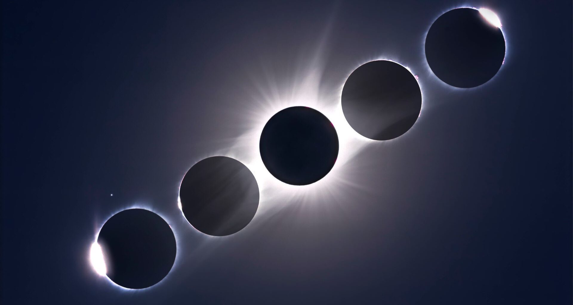 A composite image of 5 sun/moon conjunctions showing the stages of a total solar eclipse arrayed in a diagonal line in a dark sky, with the point of maximum eclipse in the middle.