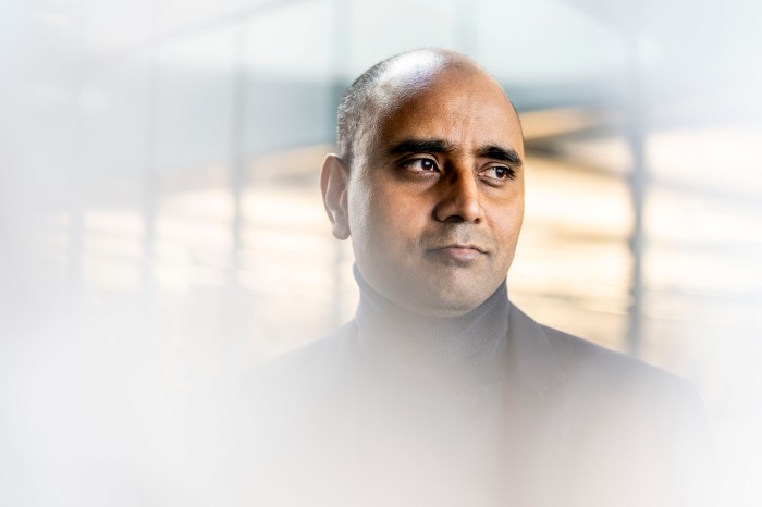 Aatmesh Shrivastava in a dark jacket, looking off to the side with a serious expression, framed by soft window light and blur.