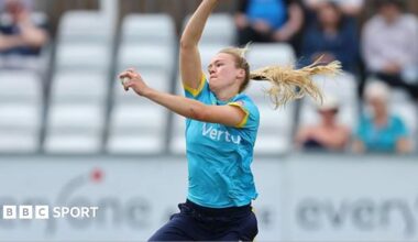 Alexa Stonehouse in sky blue shirt and navy blue trousers bowls for Warwickshire