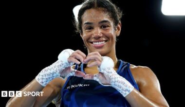 Chantelle Reid makes a heart symbol with her gloves off after winning a boxing match