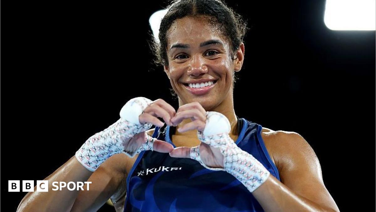 Chantelle Reid makes a heart symbol with her gloves off after winning a boxing match