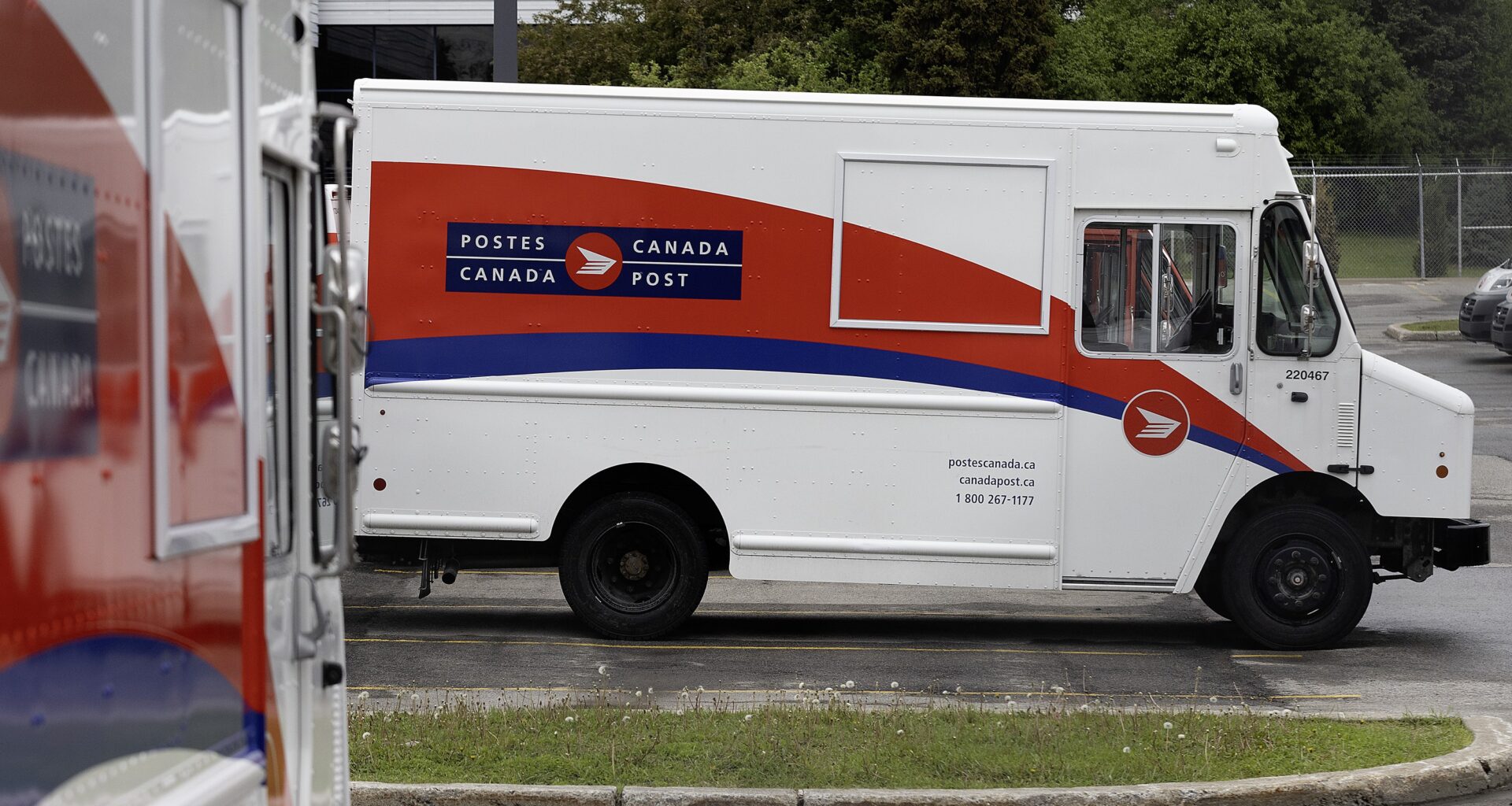 A Canada Post vehicle in a parking lot.