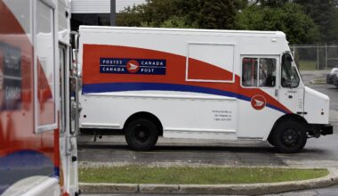 A Canada Post vehicle in a parking lot.