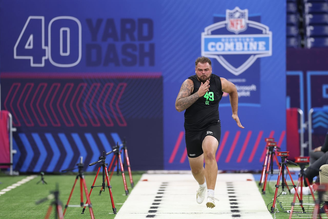A football player is shown running the 40-yard dash during a scouting combine.
