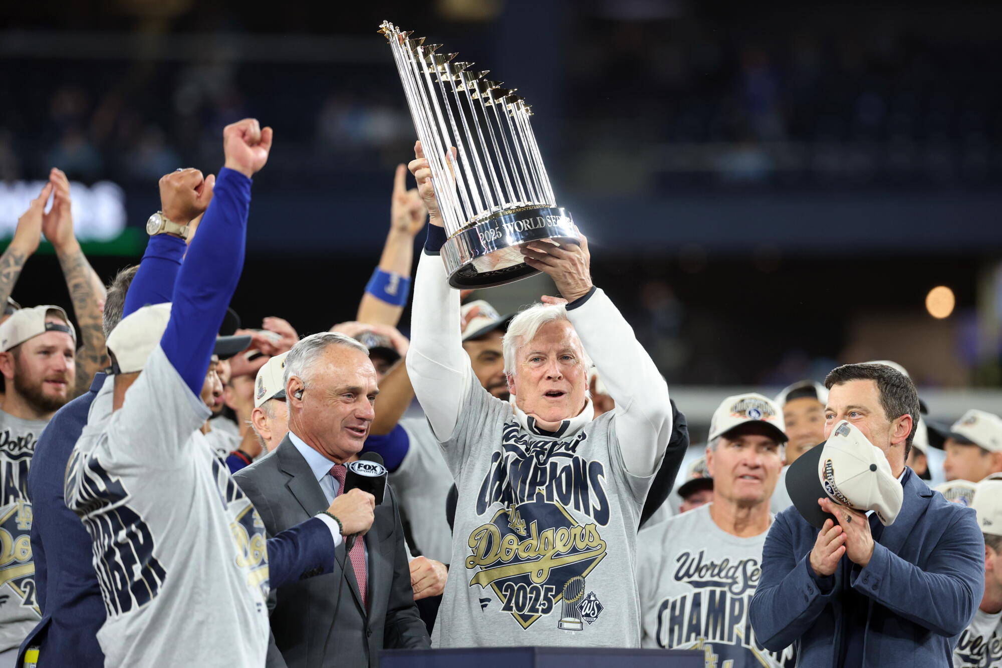 Los Angeles Dodgers owner Mark Walter hoists the World Series trophy