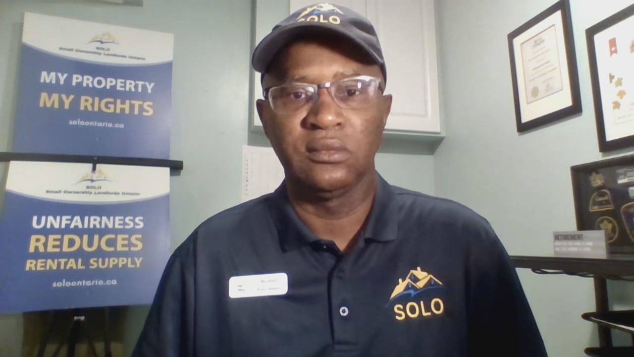 A man with a navy ball cap