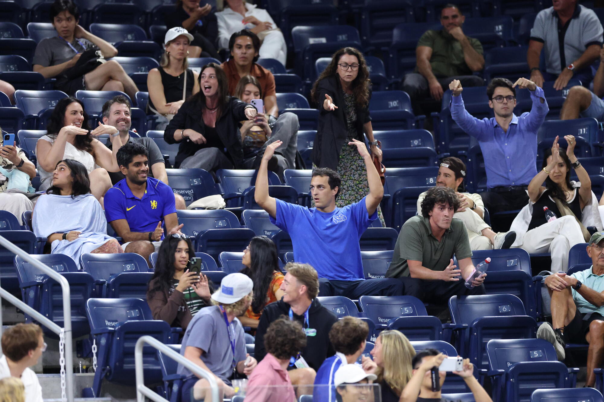 A rowdy fan reacts to being asked to leave during the fourth set of Learner Tien's match against Jakub Mensik.