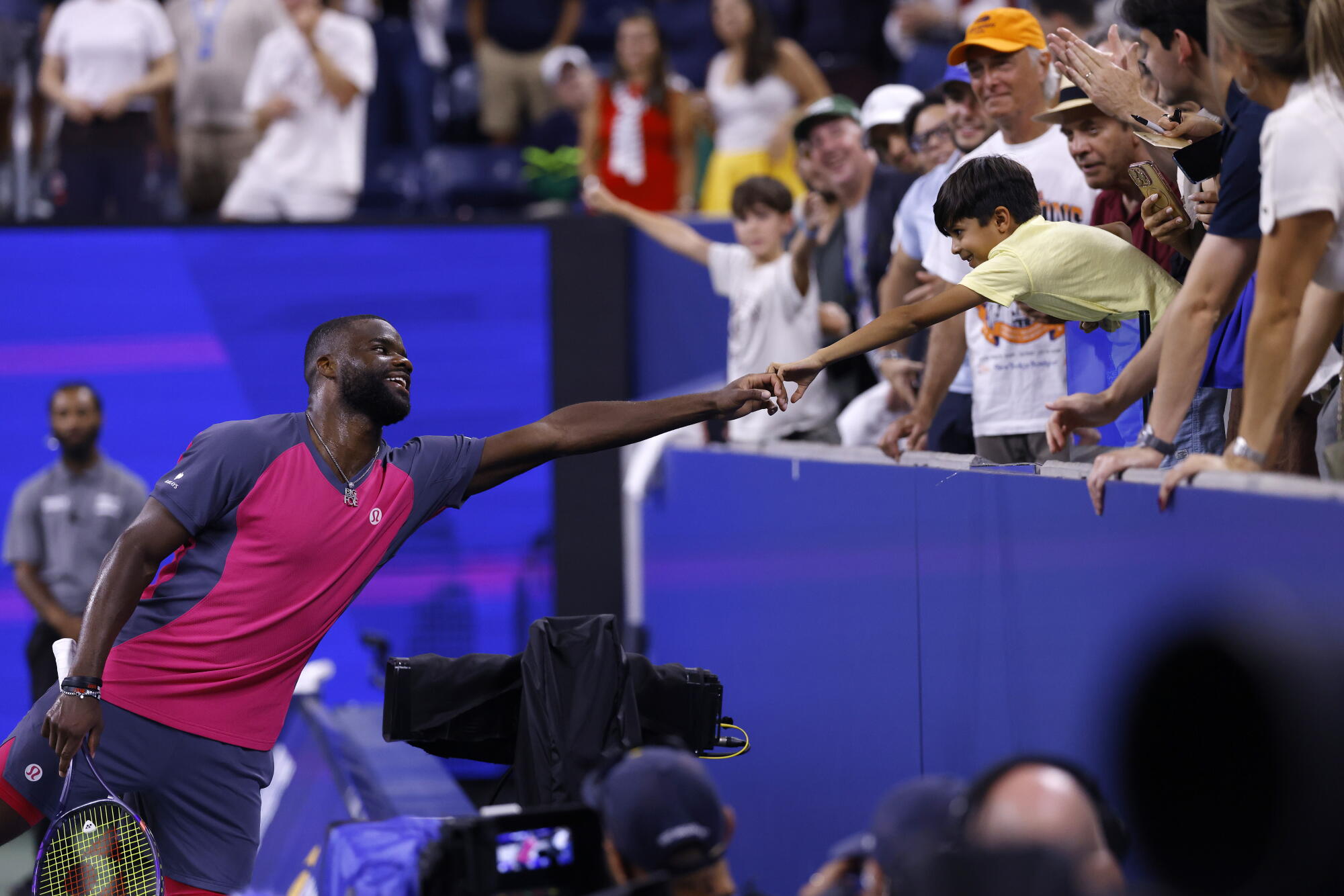 Frances Tiafoe celebrates with a fan after a win over Valentin Vacherot at the U.S. Open on Friday.