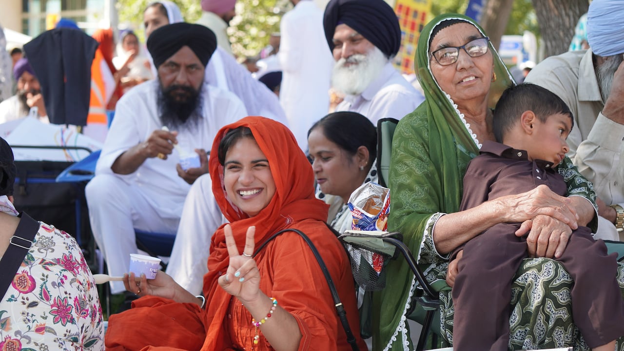 A number of people smiling at the Nagar Kirtan event.
