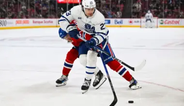 Toronto Maple Leafs left wing Matthew Knies (23) plays the puck against Montreal Canadiens defenseman David Reinbacher (64) during the third period at Bell Centre.