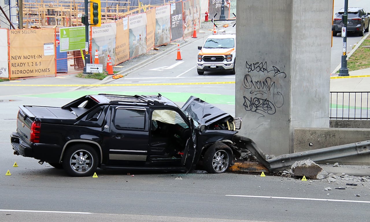 A black pickup truck smashed into a concrete pillar.