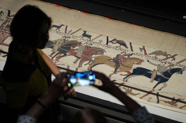 The 70-meter-long Bayeux Tapestry is displayed during a press preview at the British Museum in London after returning to England, following a historic agreement between the UK and France, Monday, Sept. 7, 2026. (AP Photo/Kin Cheung)