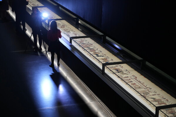 The 70-meter-long Bayeux Tapestry is displayed during a press preview at the British Museum in London after returning to England, following a historic agreement between the UK and France, Monday, Sept. 7, 2026. (AP Photo/Kin Cheung)