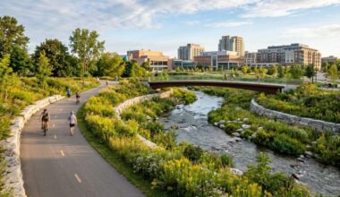 Riverwalk Downtown Brampton naturalized Etobicoke Creek channel with pedestrian pathways and green parkland