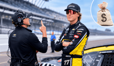NASCAR Cup Series driver Carson Hocevar (77) stands by his car Saturday, July 25, 2026, during qualifying for the Brickyard 400 at Indianapolis Motor Speedway with a stock image of a money bag in the top right corner.